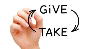 give and take written on a board – balance between the two is needed to avoid burnout